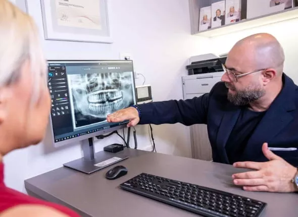 Dentist reviewing a dental X-ray with a patient during a consultation